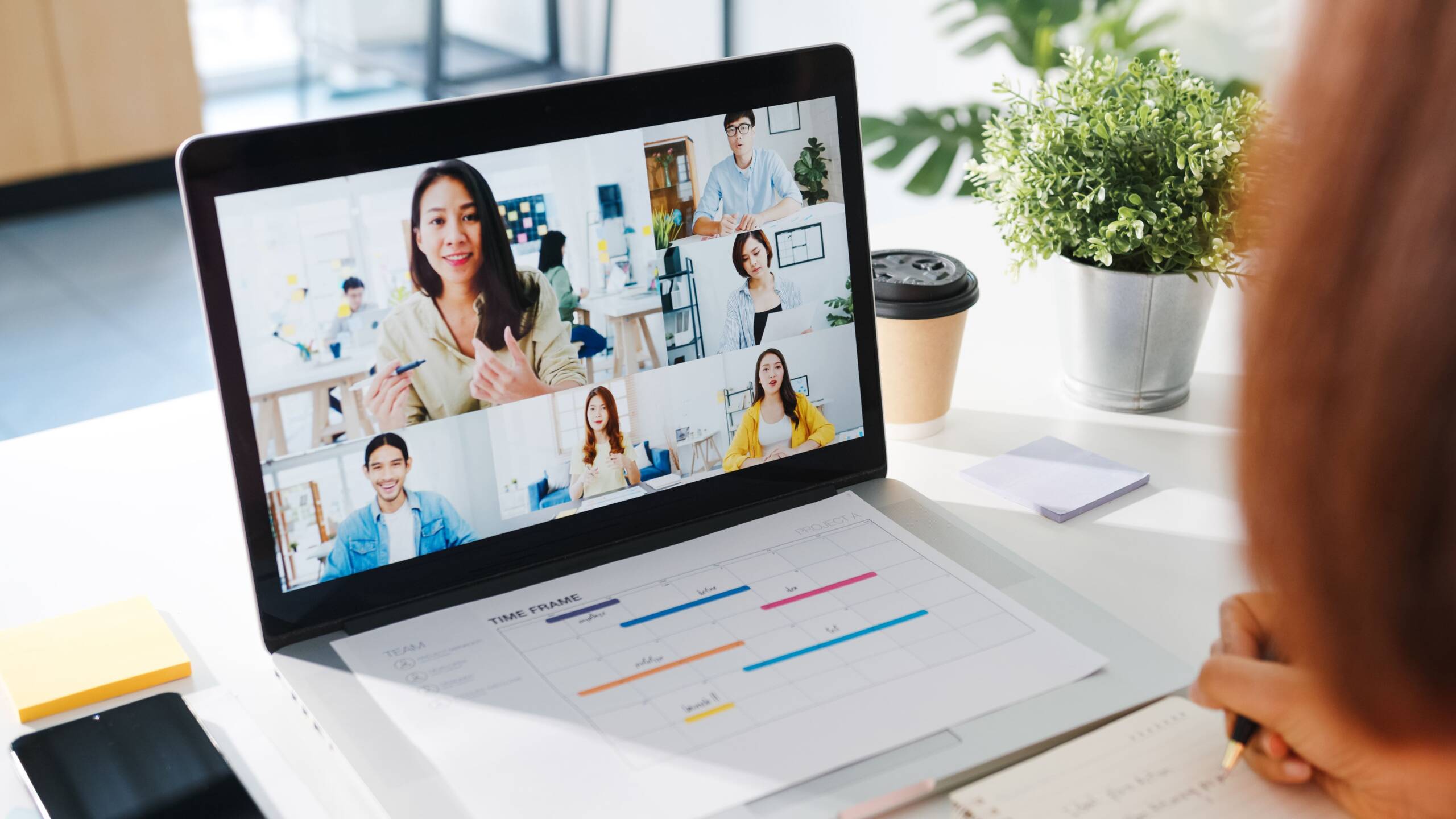 young asia businesswoman using laptop talk colleague about plan video call meeting while work from home living room (1)